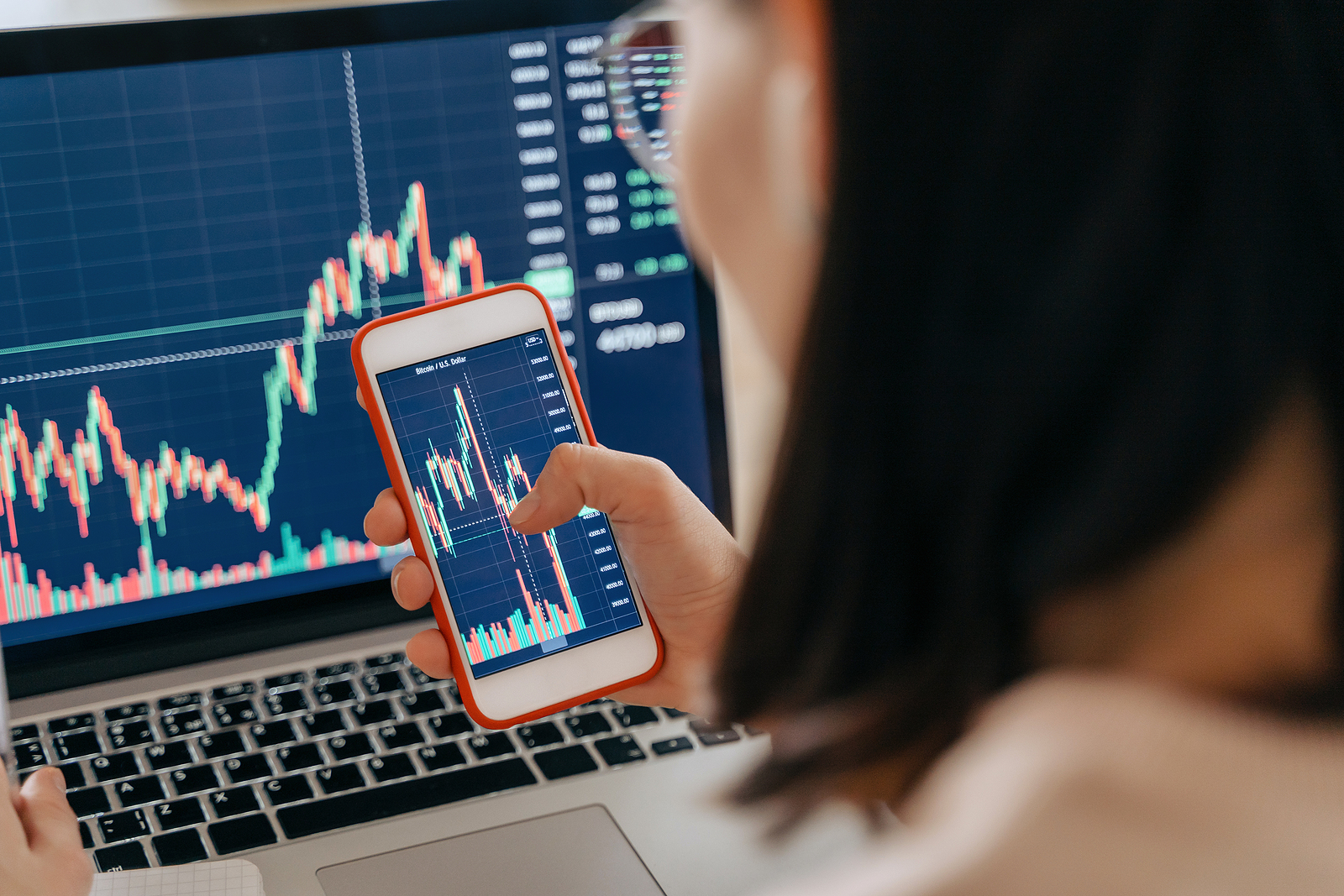 Woman analyzing stock charts